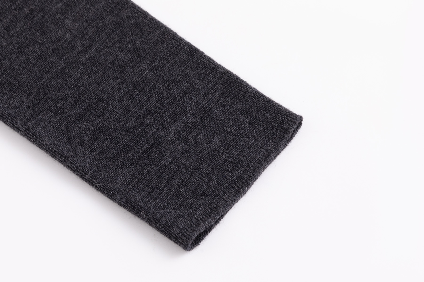 Cuff detail on charcoal 18G seamless wool sweater sample