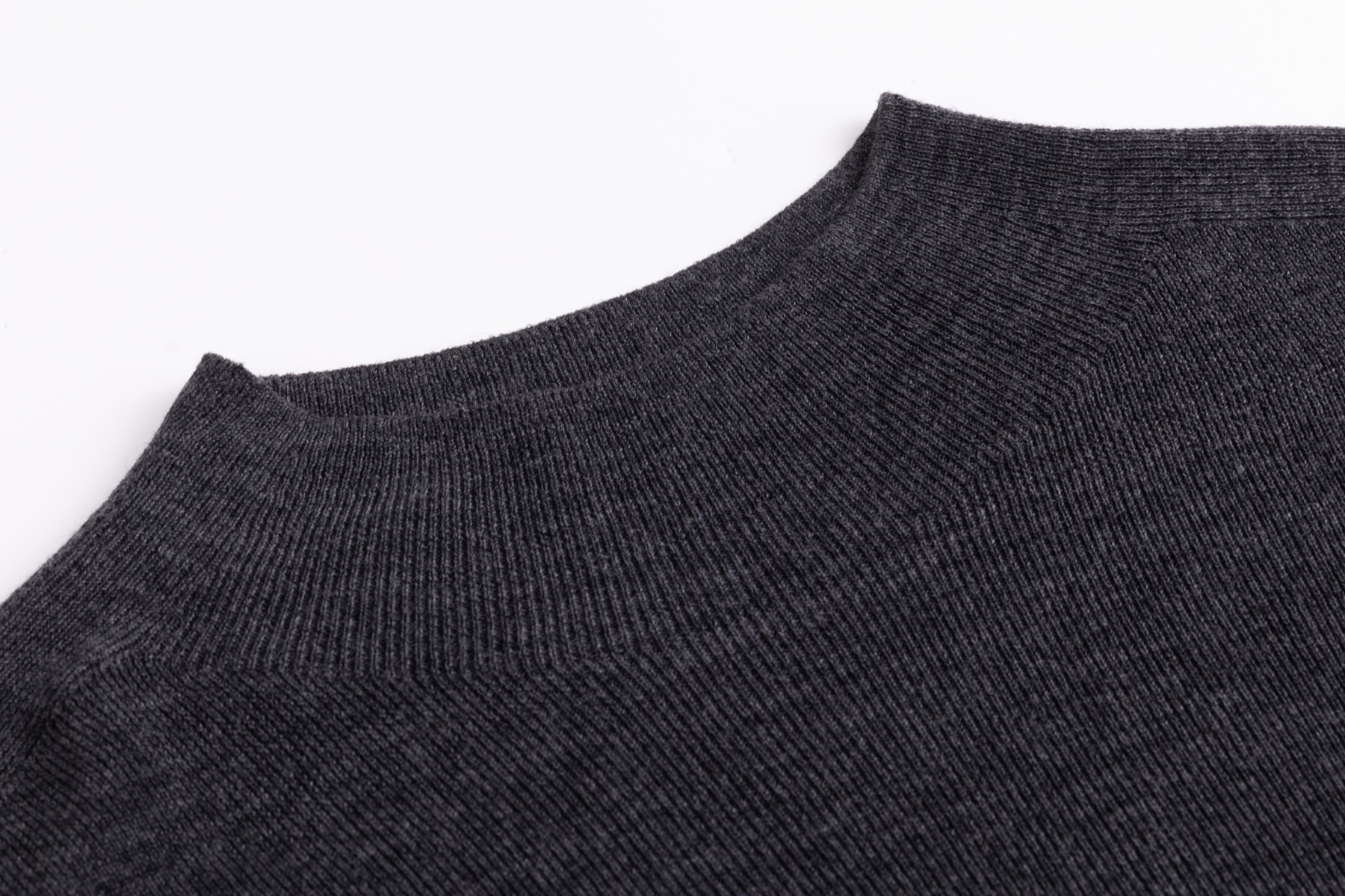 Fine-gauge neckline detail on charcoal seamless wool sweater sample